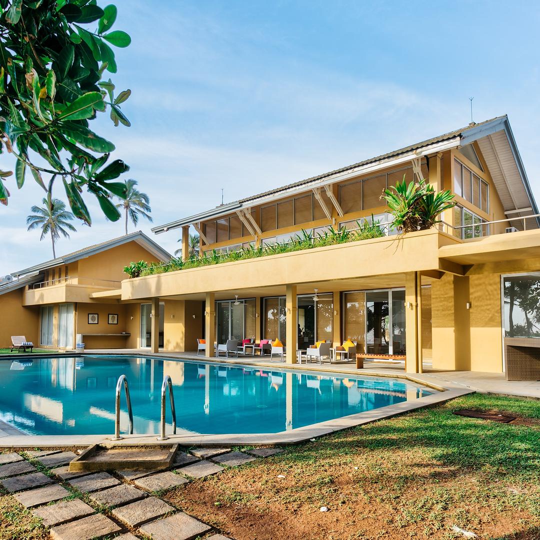 Wadduwa Beach Villa pool and terrace illuminated at evening with warm lighting