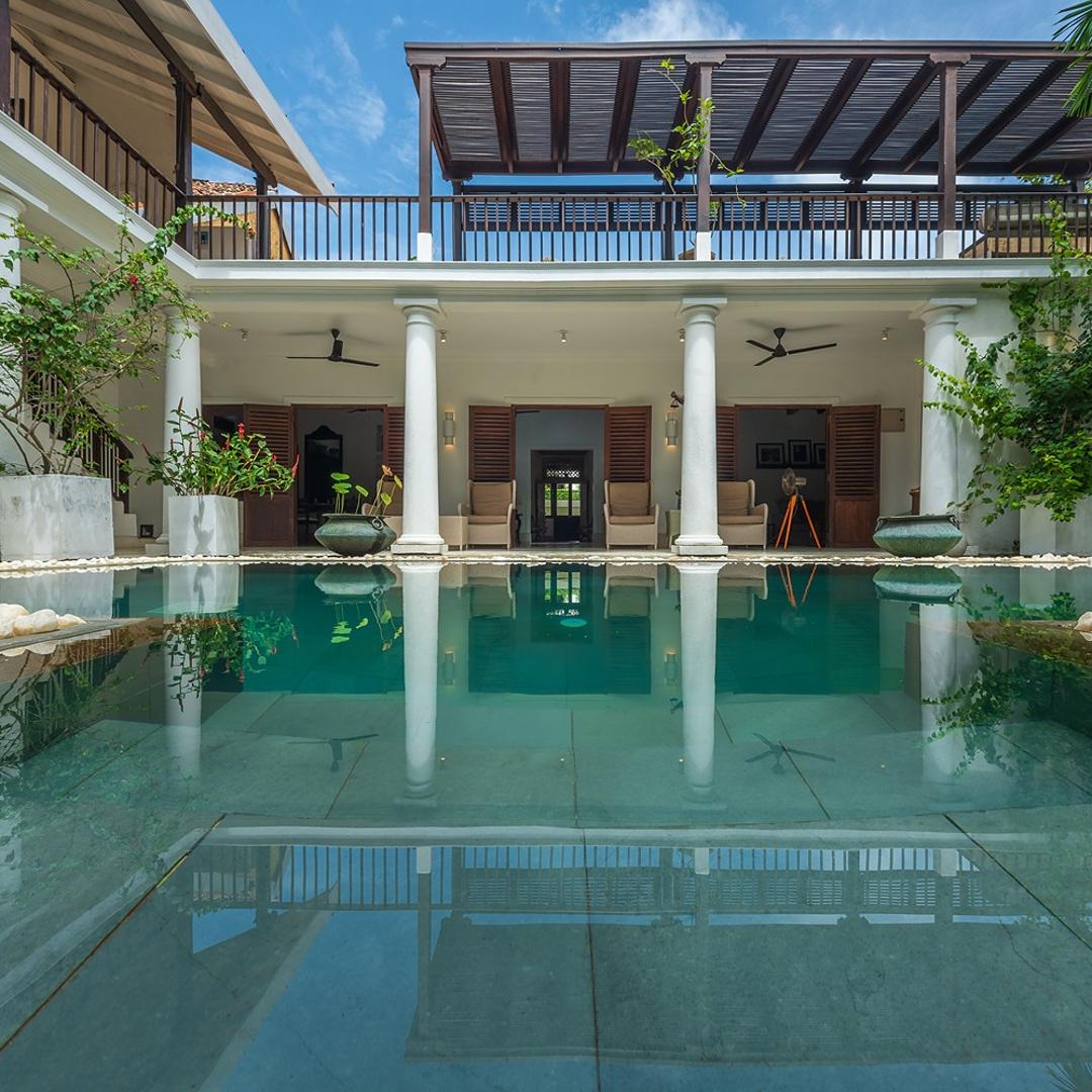 32 Middle Street Galle Fort courtyard pool with white colonial pillars and sun loungers