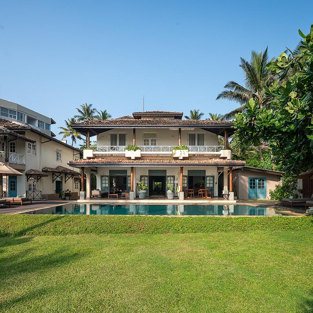 On The Rocks Unawatuna exterior with pool, lawn and two villa buildings