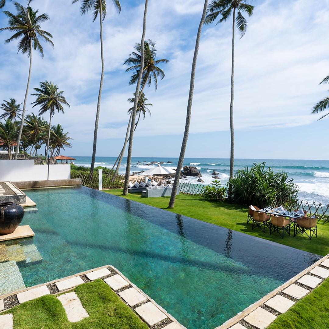 Villa Salt Talpe ground level view of pool, garden and Indian Ocean beyond