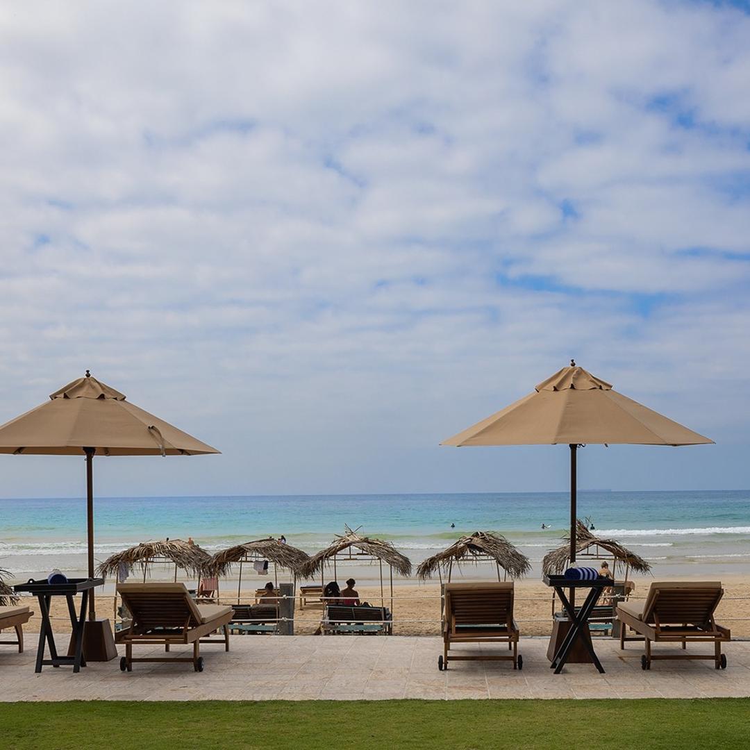 Ahangama beachfront villa pool with sun loungers and umbrellas leading to beach