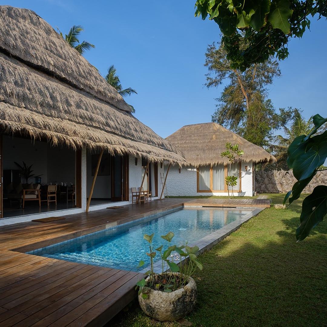 Boho House Mirissa pool with thatched villa facade and ocean view