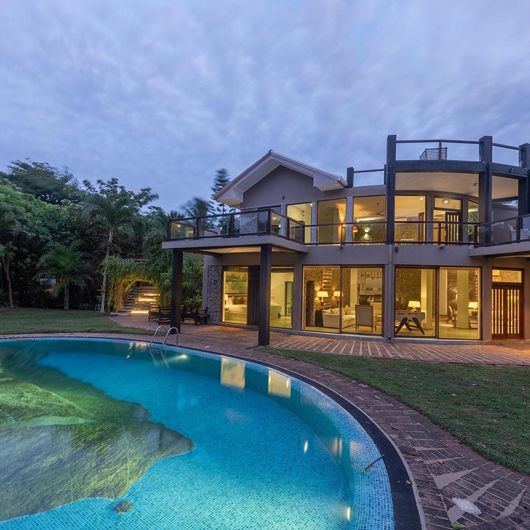 Casa Tua villa and pool illuminated at night