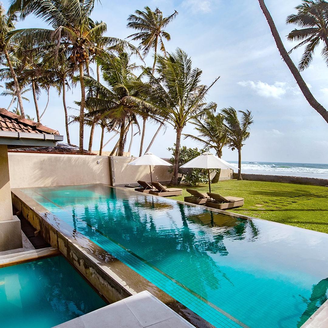 Cottage Kabalana pool with coconut palms and beachside pavilion, Ahangama, Sri Lanka