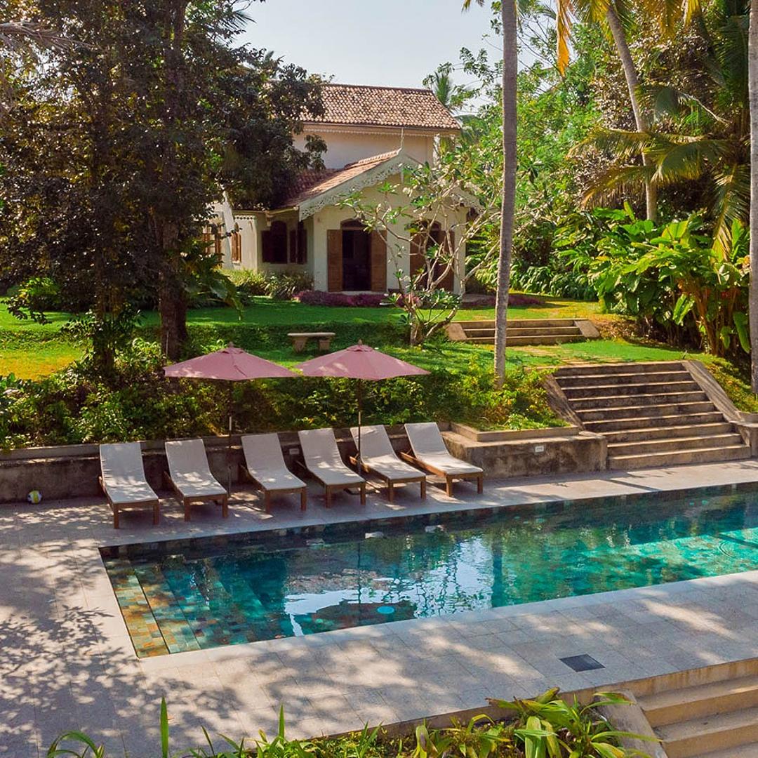 Aerial side angle of Island Villa Ahangama pool in tropical garden, Ahangama, Sri Lanka
