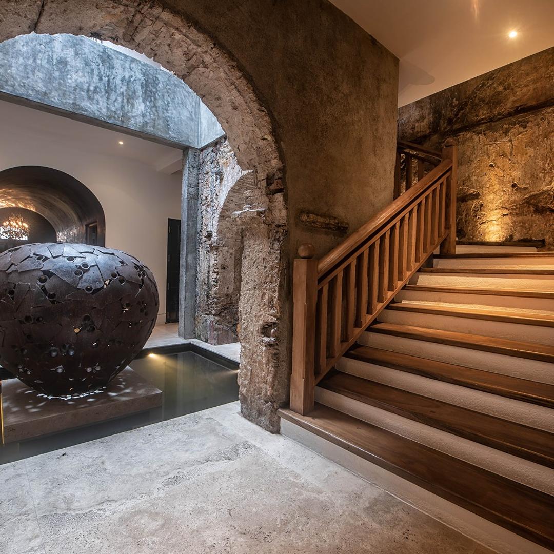 Lit staircase with urn sculpture at base and arched corridor, No. 77 Leyn Baan, Galle Fort