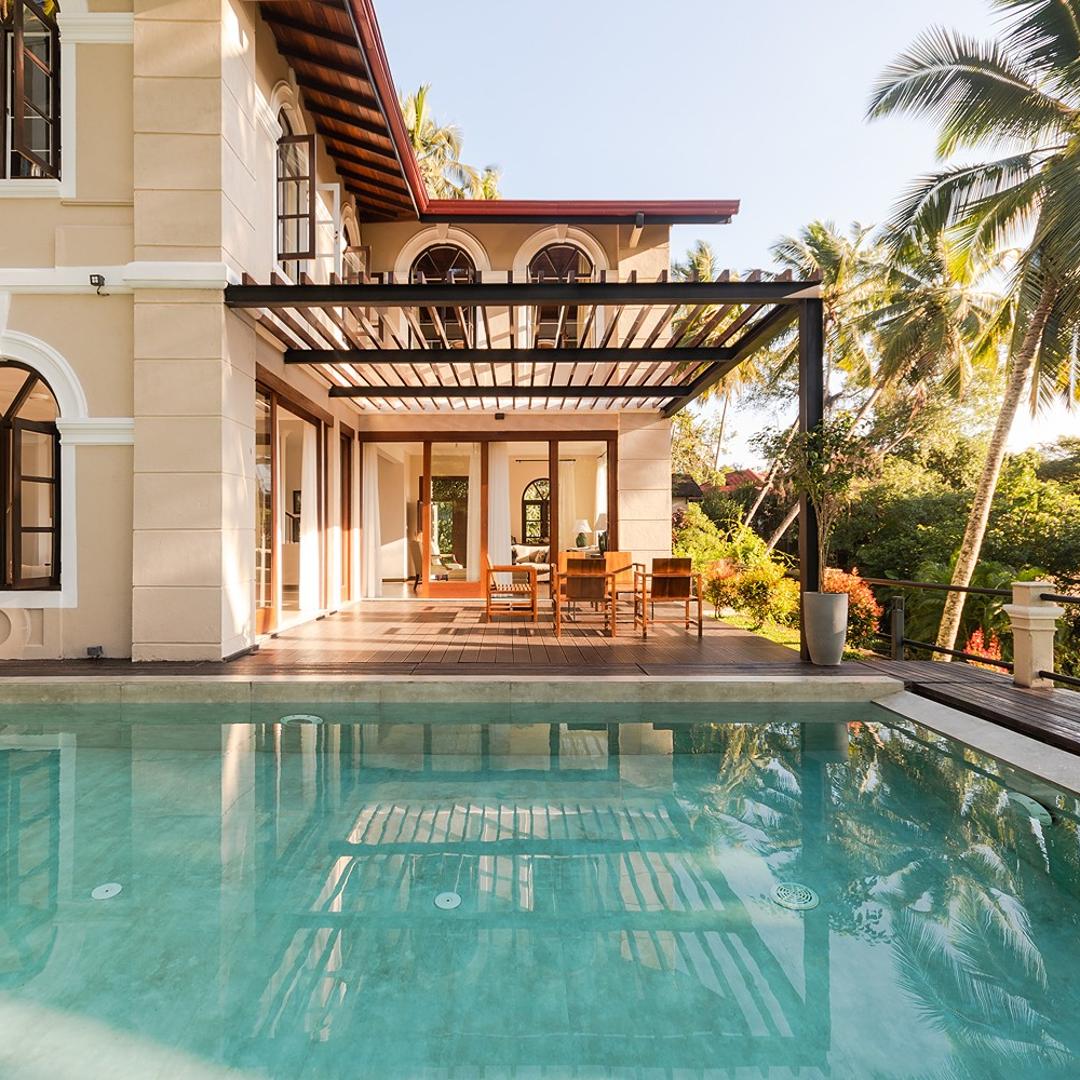 Pool and villa facade with palm trees, Merak Digana