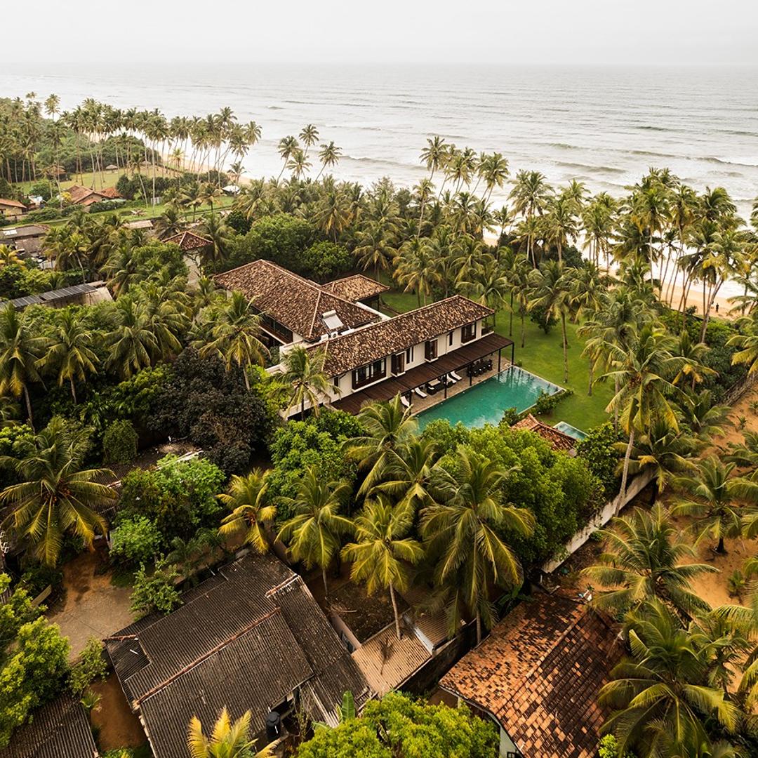 Aerial villa surrounded by palms, The Villa by CC Wadduwa