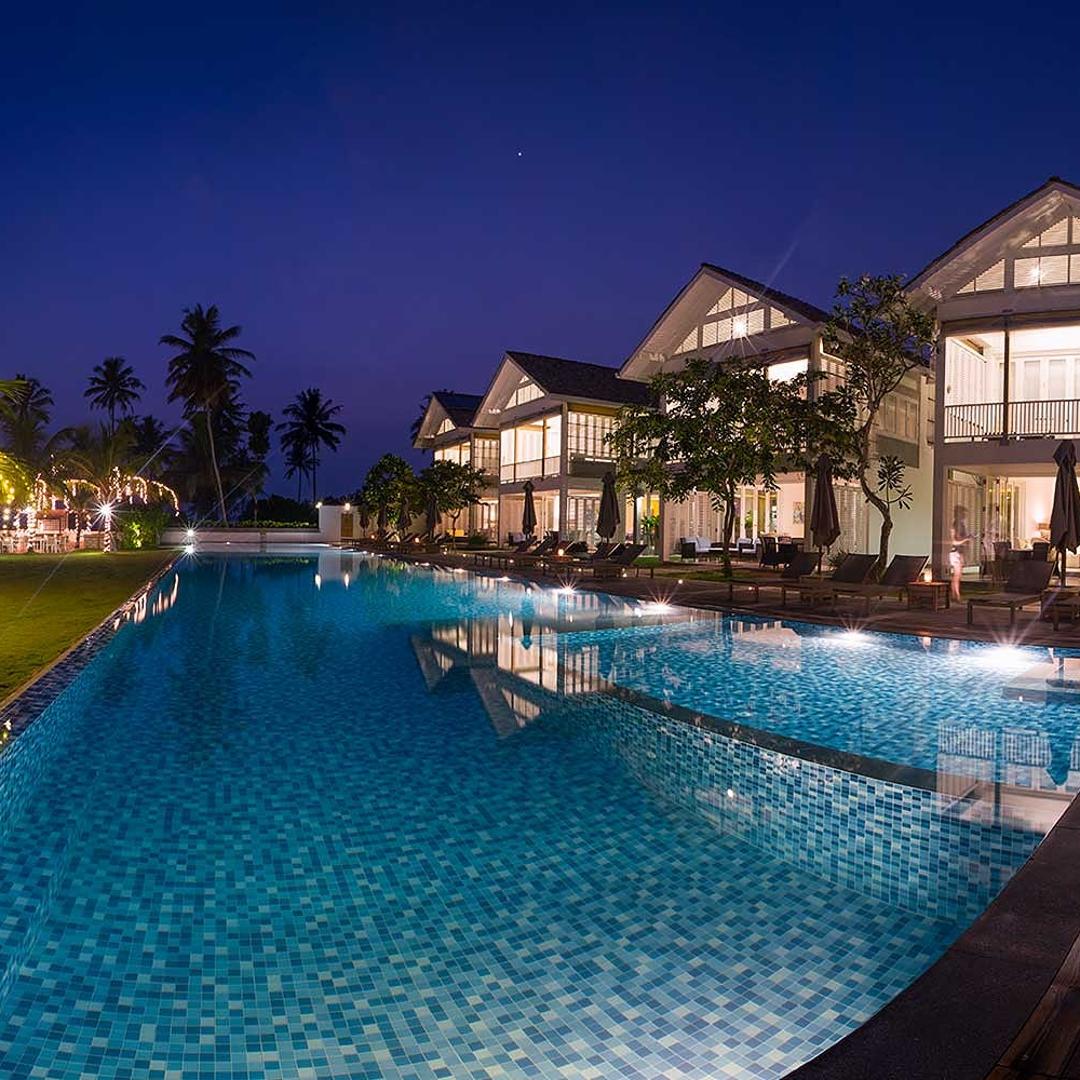 Villas at night with lit pool, Sri Sharavi Mirissa