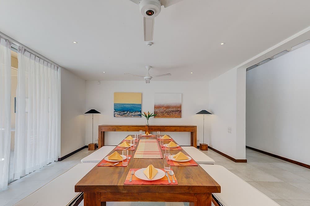 Villa dining area with solid wood table and natural light in Wadduwa Sri Lanka
