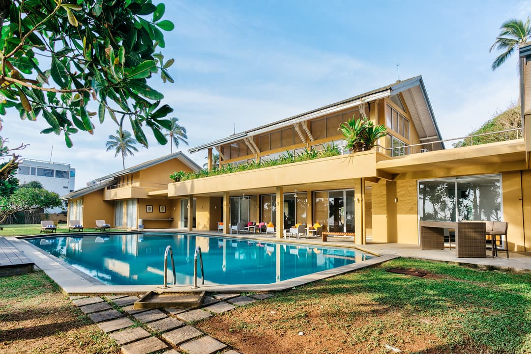 Wadduwa Beach Villa pool and terrace illuminated at evening with warm lighting