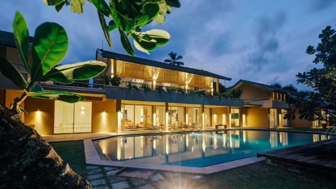 Villa bedroom with warm tones, contemporary furnishings and air conditioning