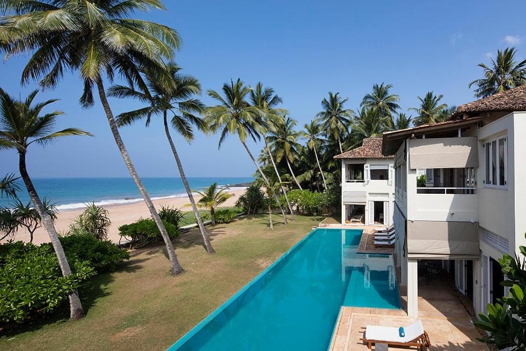 Aerial view of Sri Villas Induruwa showing infinity pool and beachfront setting