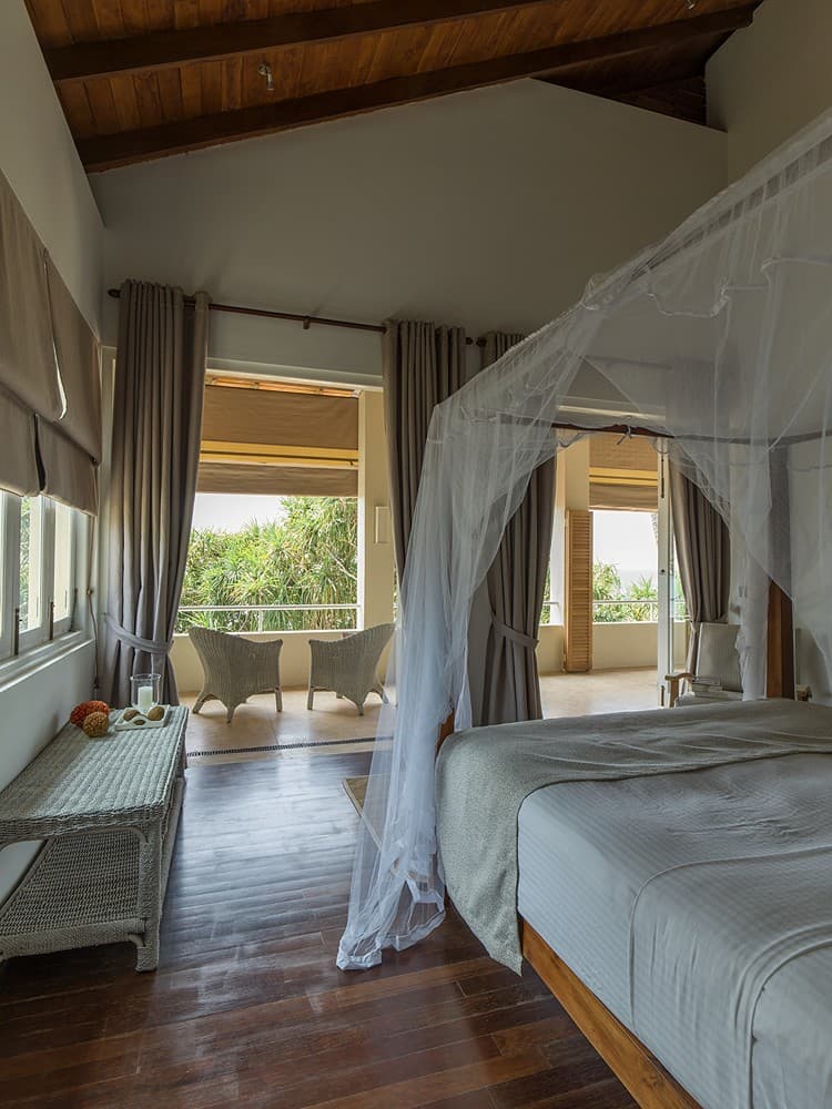 Araliya wing king suite with draped white canopy and wooden flooring, Induruwa