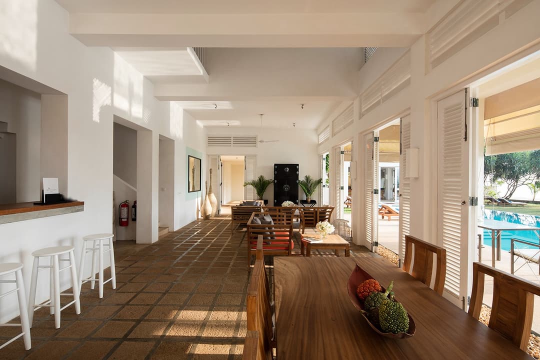 Nisala wing corridor with poolside and ocean views at Sri Villas Induruwa