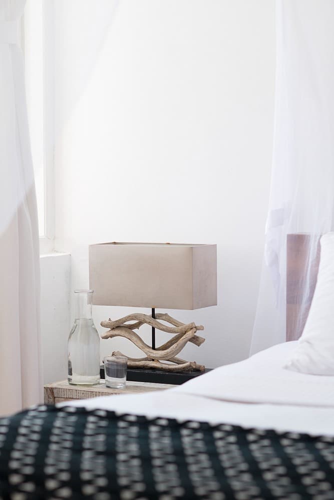 Nisala wing ocean suite bedroom with white linens and sea view at Sri Villas Induruwa