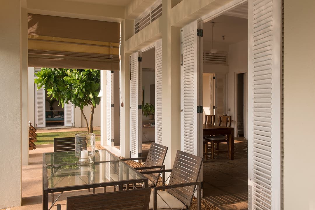 Nisala wing private terrace with outdoor seating and panoramic ocean views
