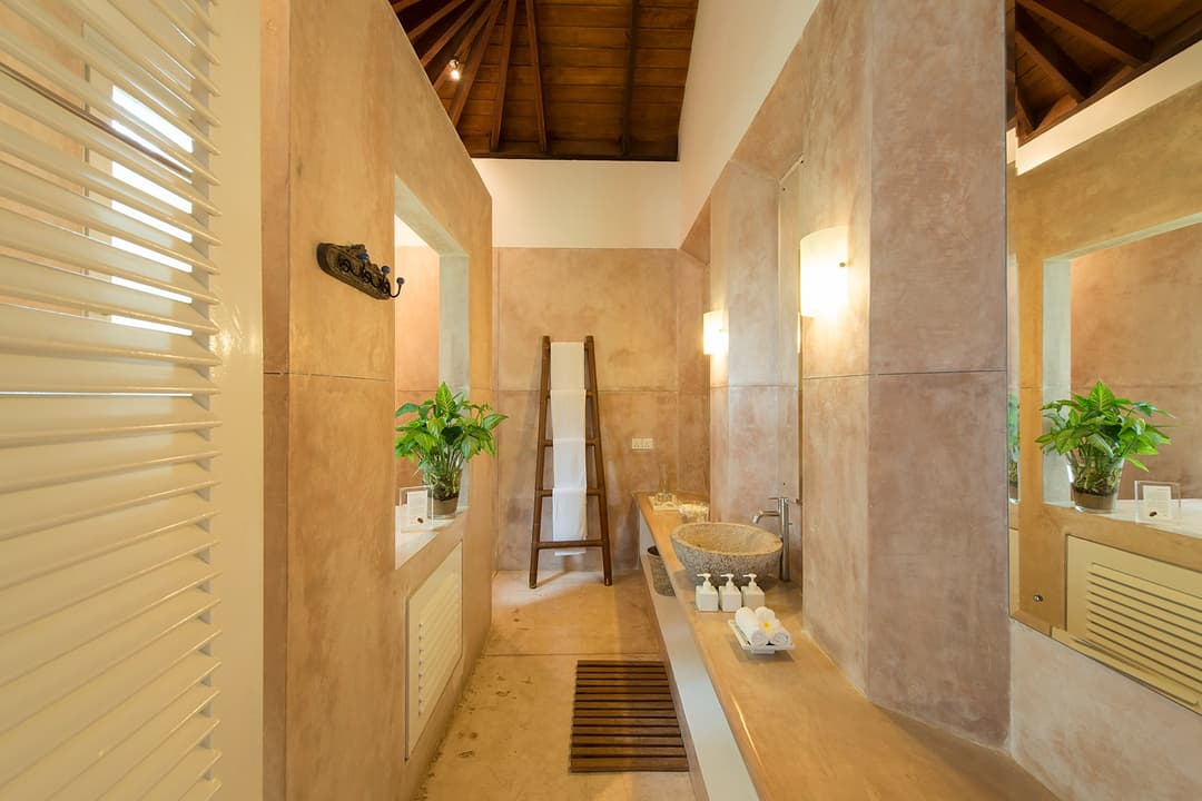 Sagara wing garden suite bathroom with stone finishes and tropical plant detail