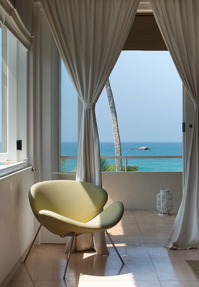 Sagara wing king suite bedroom with white linens and ocean-facing windows