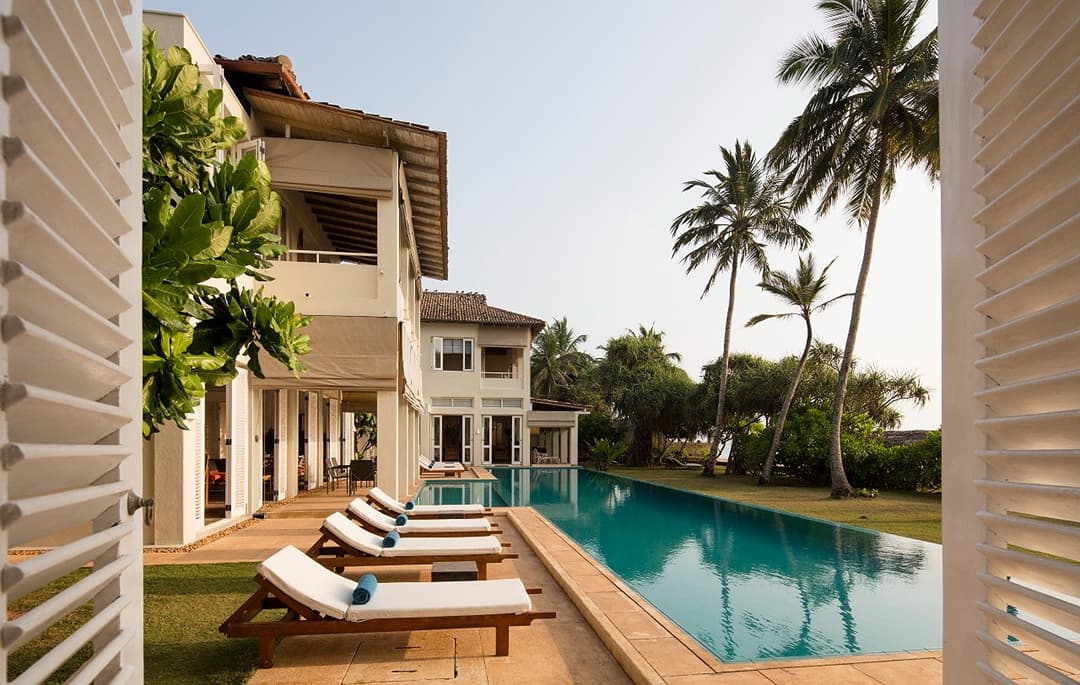 Sagara wing king suite with curtained ocean view windows and relaxed coastal decor