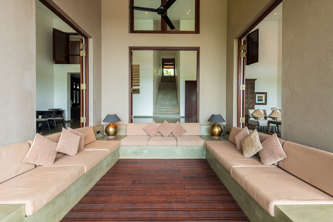Wide-angle interior view of a Bolgoda Lake villa living room with timber floors