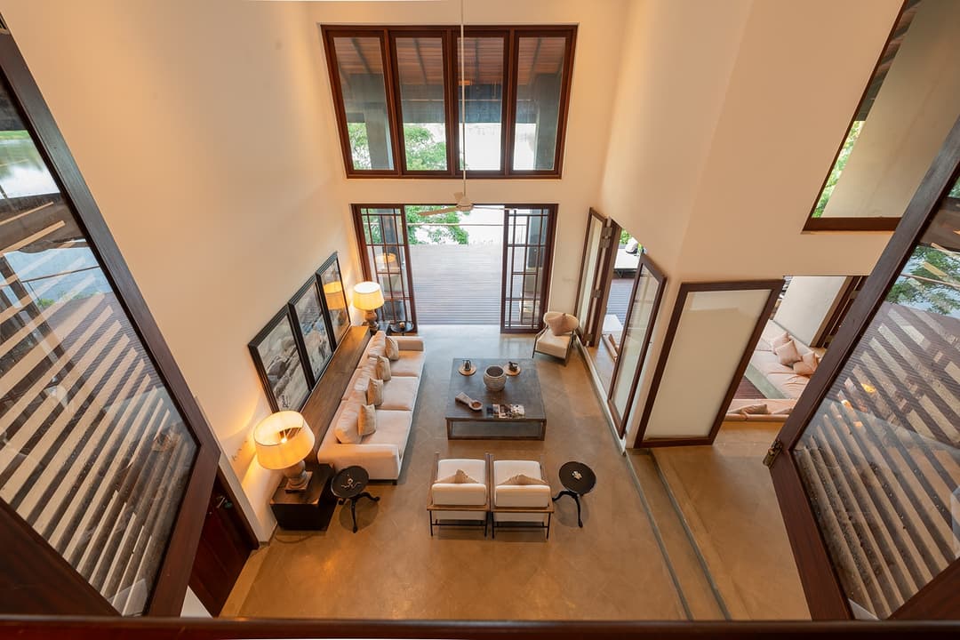 Overhead view of villa interior lounge leading to timber deck and Bolgoda Lake