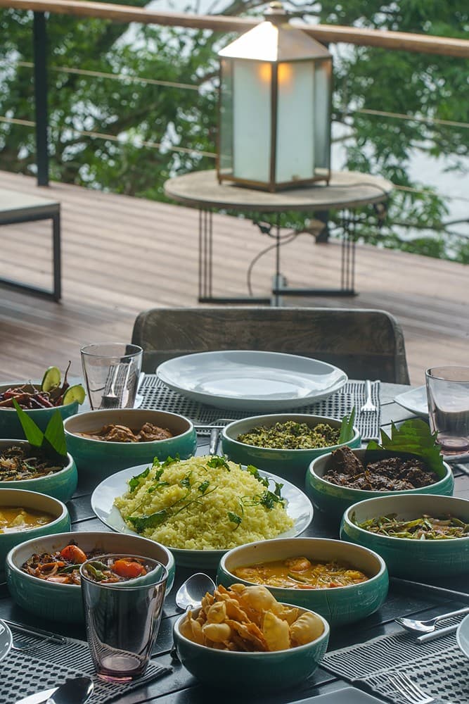 Sri Lankan rice and curry feast served on outdoor deck at a Bolgoda Lake villa