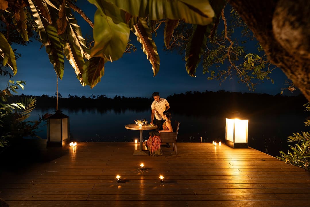 Celeste Bolgoda pool deck illuminated at night with candles and Bolgoda Lake beyond