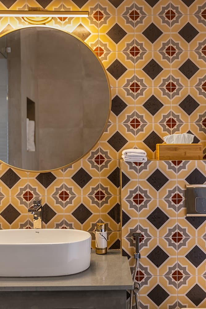 Villa bathroom detail with mosaic circular mirror surround and vessel basin