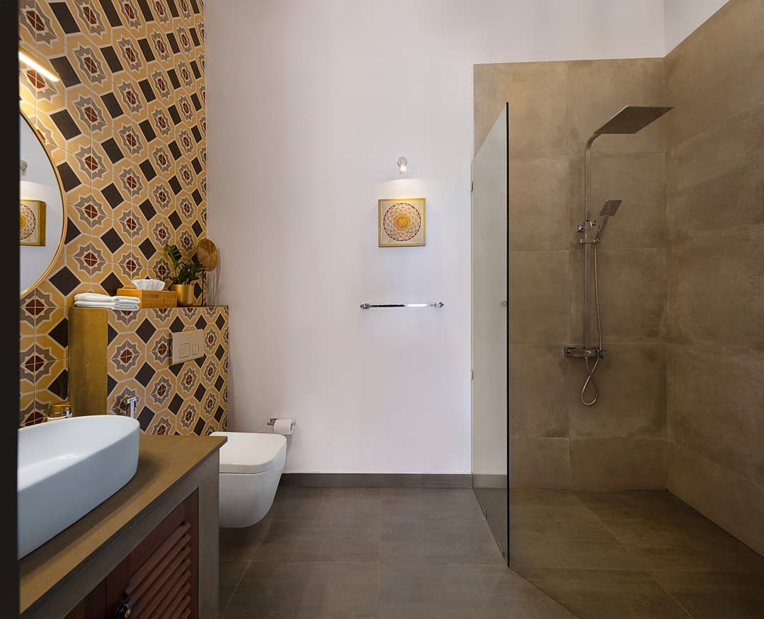 Villa bathroom with rain shower cubicle and hand-painted Moroccan tiles