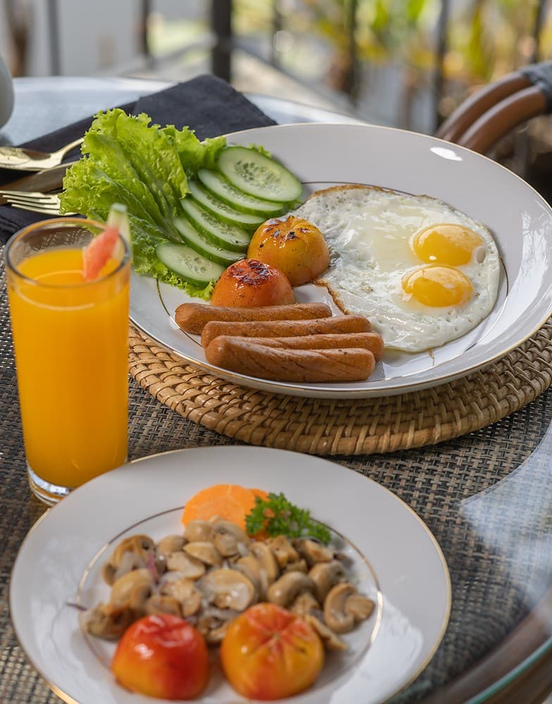 Villa chef-prepared breakfast plate with fresh fruit and orange juice
