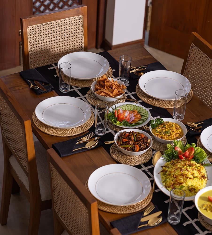 Villa dining table candlelit and formally set for an evening meal in Bentota