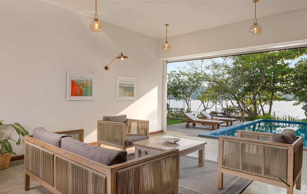 Villa open-plan living room with pool views and contemporary lounge furniture
