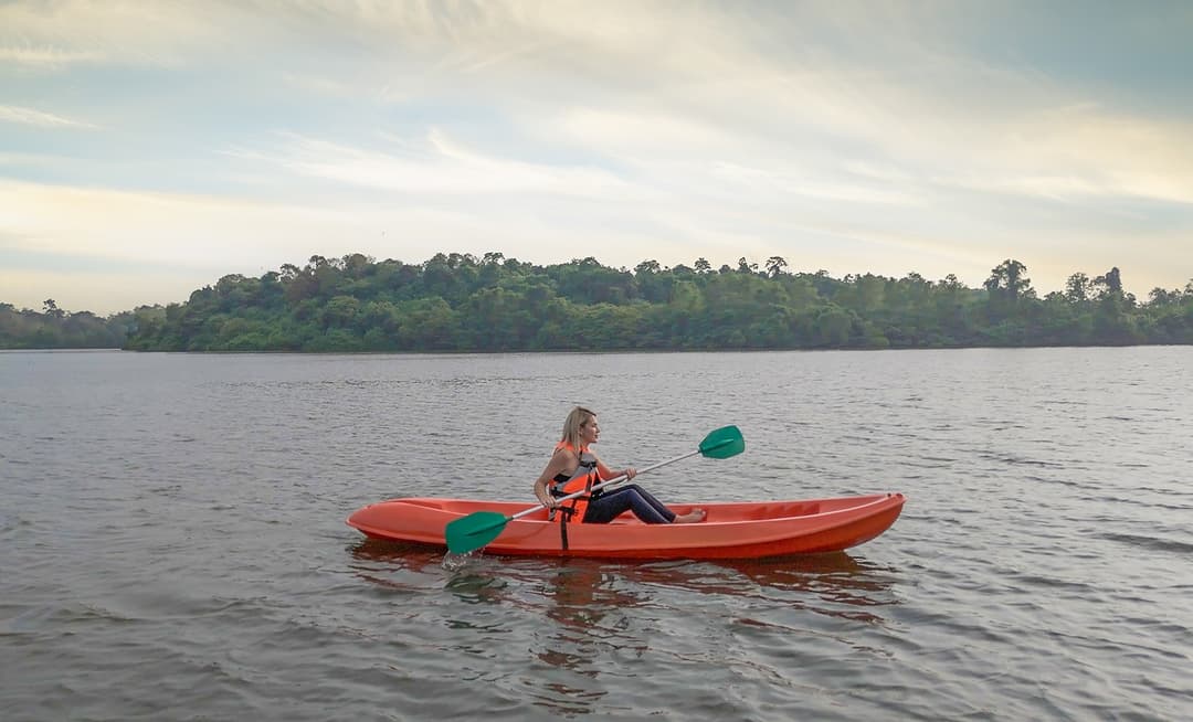 Woman kayaking on Dedduwa Lake in a red kayak near Bentota Sri Lanka