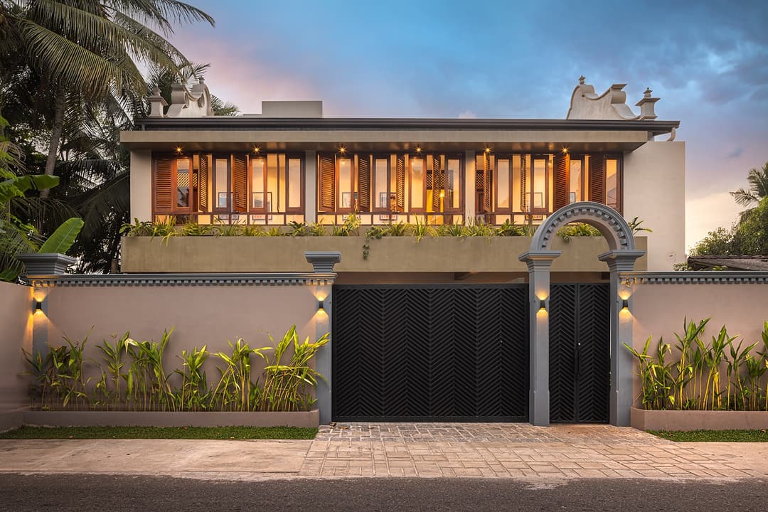 Yahva Bentota villa entrance with signature black arched gates and mature trees
