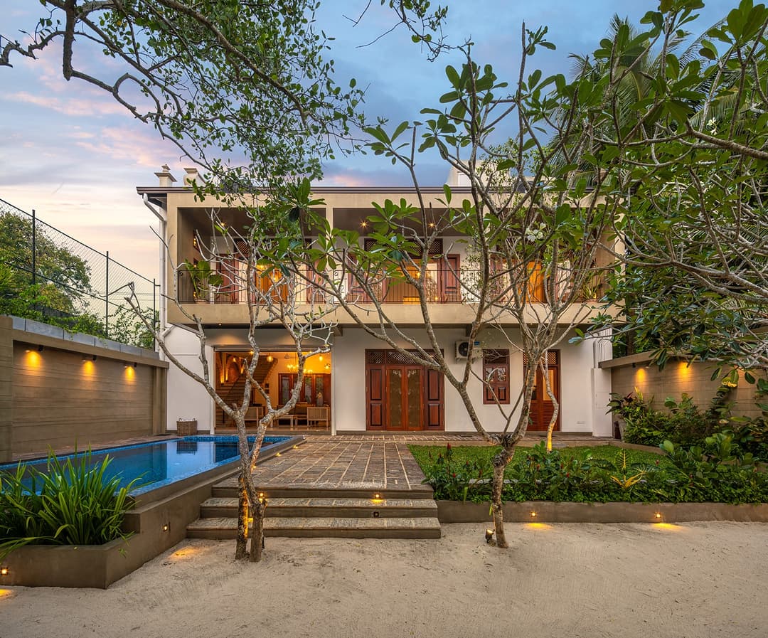 Yahva Bentota villa exterior garden and pool illuminated at dusk
