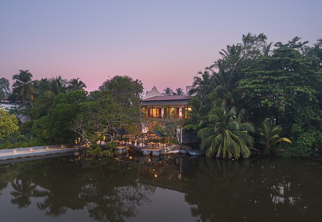 Yahva Bentota villa reflected in Dedduwa Lake at pink dusk