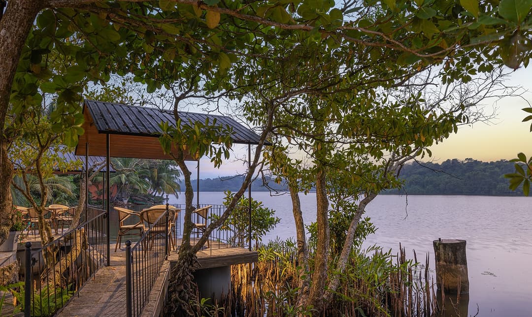 Yahva Bentota villa pool deck with lake views under tropical tree canopy