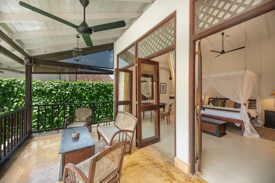 Villa bedroom open to terrace with tropical garden views inside Galle Fort