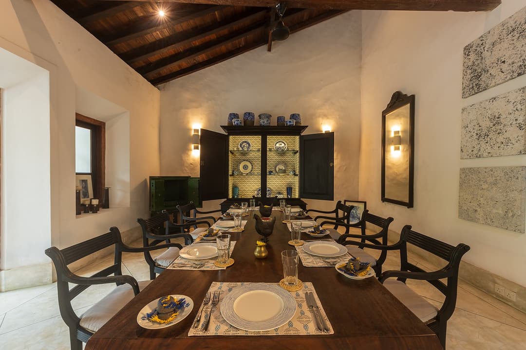 Villa dining room with dark timber ceiling and colonial furniture inside Galle Fort