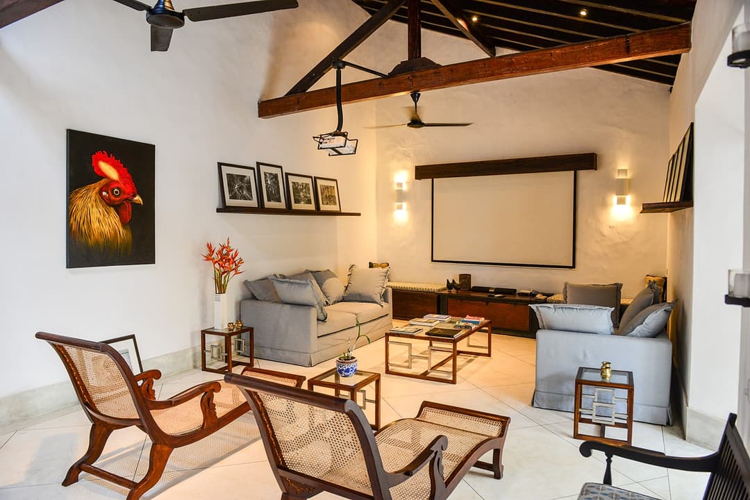 Villa living room with original artwork, ceiling fan and colonial timber interior