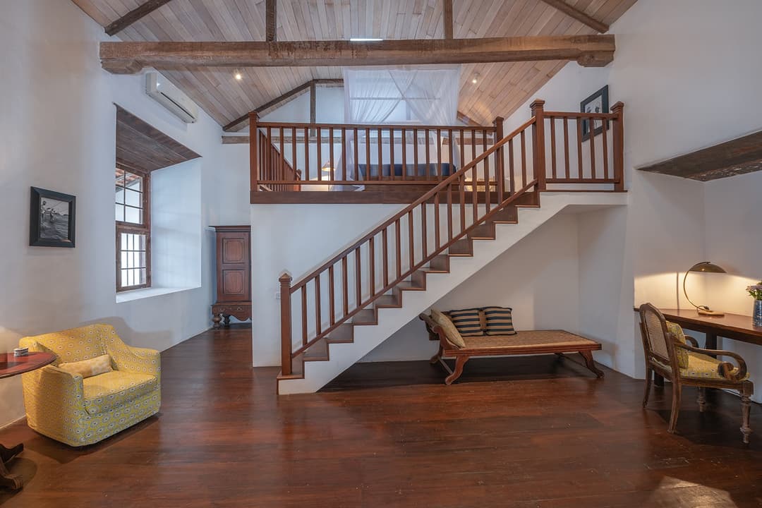 Villa mezzanine level staircase with lounge area below inside Galle Fort colonial villa