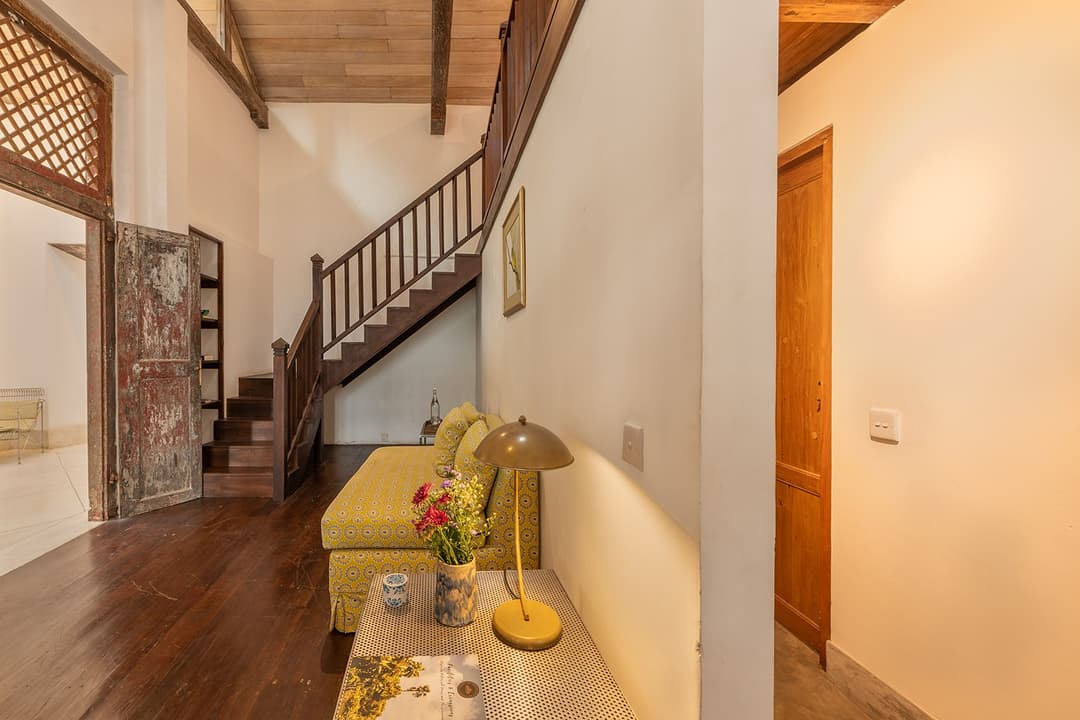 Villa staircase landing with tropical artwork and timber balustrade in Galle Fort