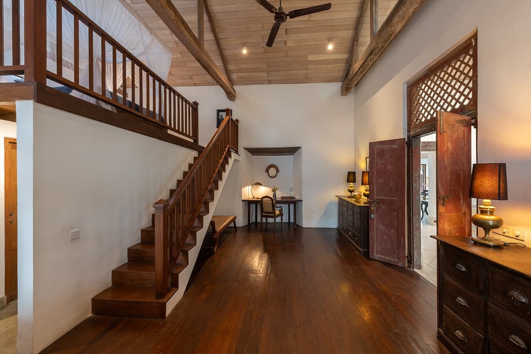 Villa whitewashed staircase with dark timber balustrade inside Galle Fort