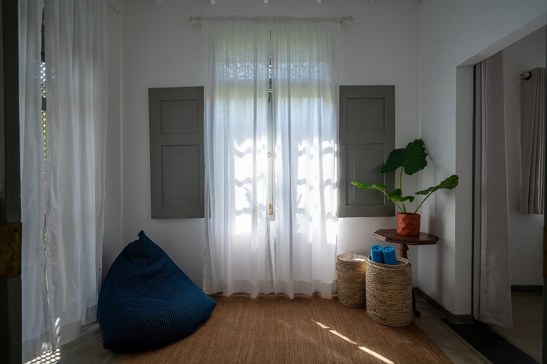 Beachfront villa bedroom with white curtains and natural light Unawatuna Sri Lanka