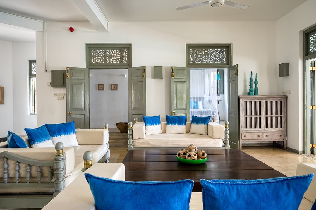 Beachfront villa master suite balcony with palm trees and Indian Ocean view