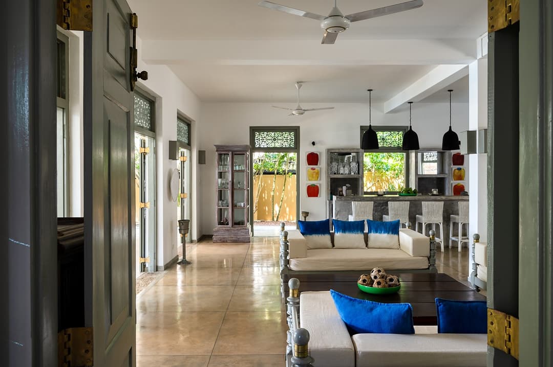 Beachfront villa master bedroom with four-poster bed and arched doorway Unawatuna