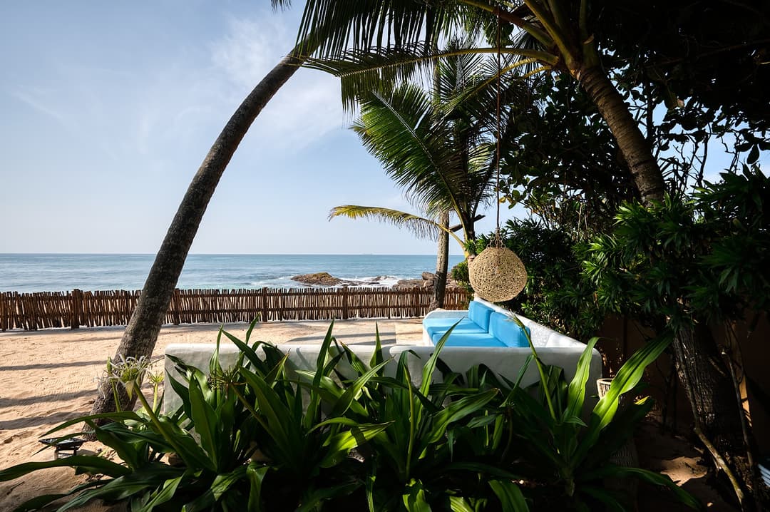 Beachfront villa pool deck with coconut palms and direct beach access Unawatuna