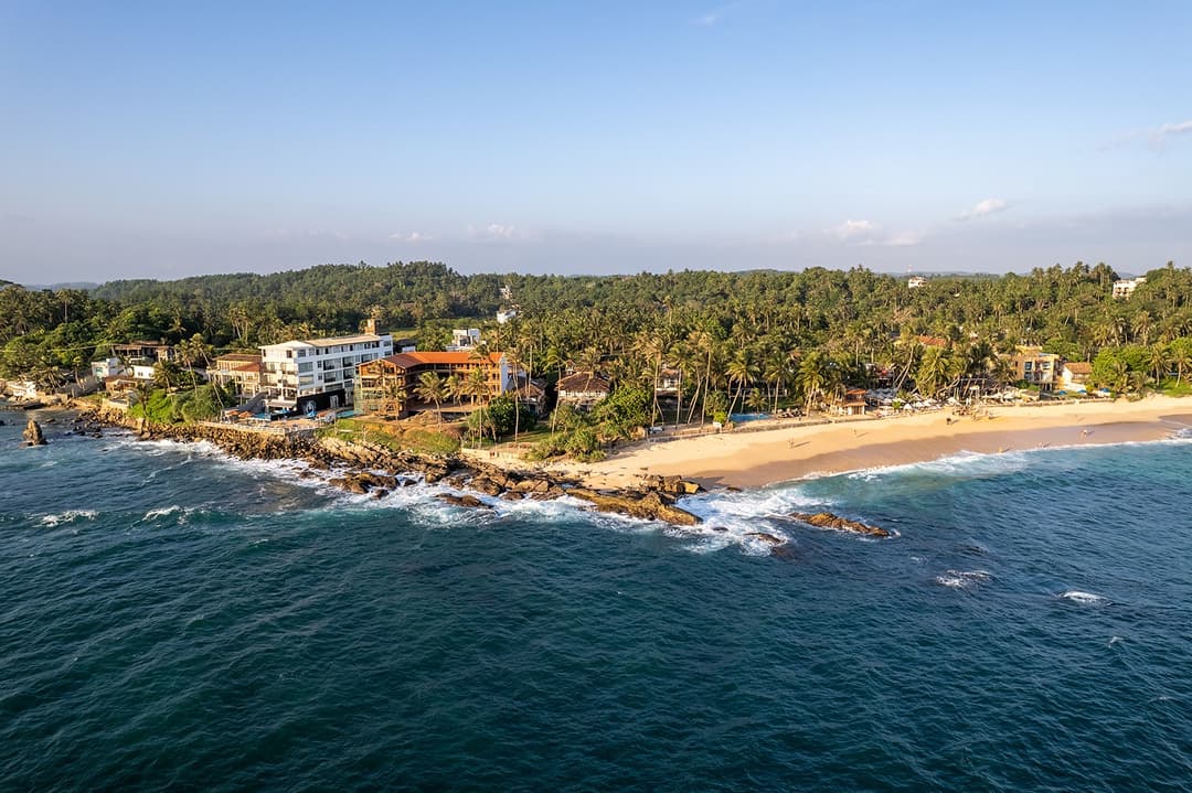 Aerial view of Villa Bleu Unawatuna coastline with Indian Ocean and palm trees