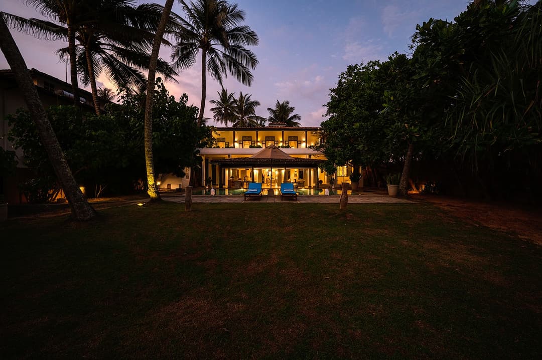 Villa Bleu Unawatuna exterior facade with garden terrace and tropical trees